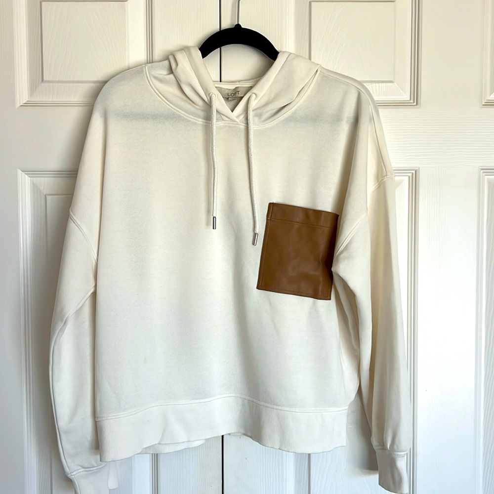 Cream colored lightweight hoodie with a faux brown oversized pocket